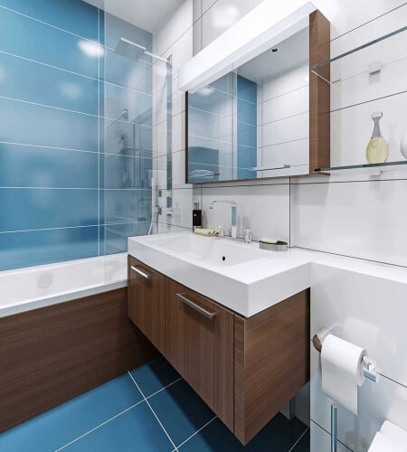 Salle de bain carrelage bleu et meuble en bois travaux réalisés par Atelier Sésame